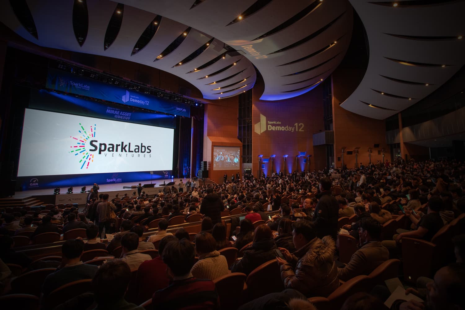 SparkLabs Demo Day 12, with the SparkLabs Ventures logo on the main screen